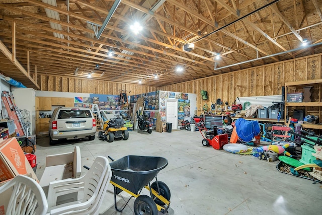 garage with a workshop area and a garage door opener