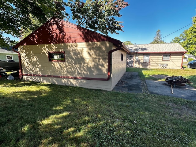 view of property exterior featuring a lawn and a patio area