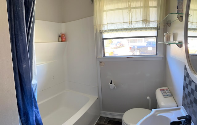 full bathroom featuring shower / tub combo with curtain, sink, and toilet