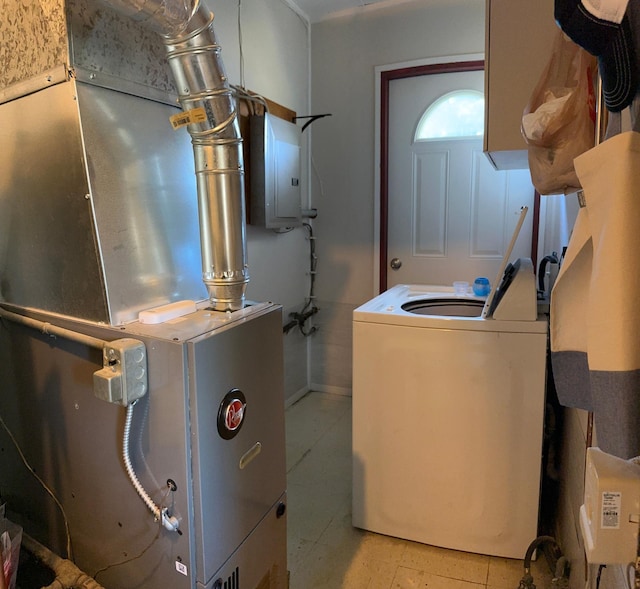 utility room with washer / clothes dryer, electric panel, and heating unit