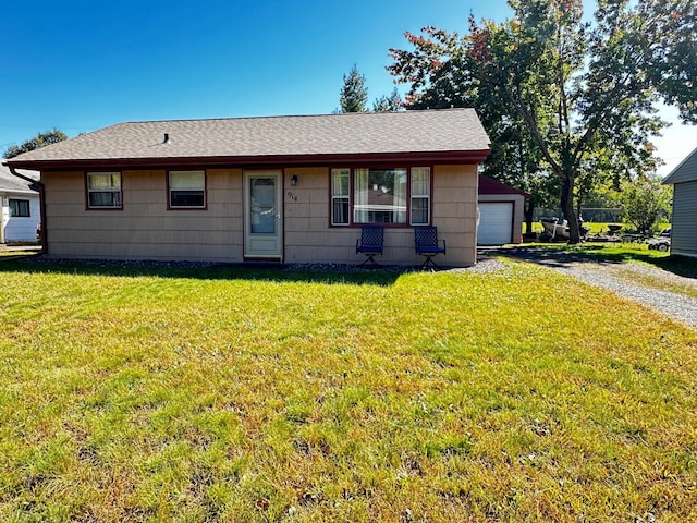 view of front of property with a front yard and a garage