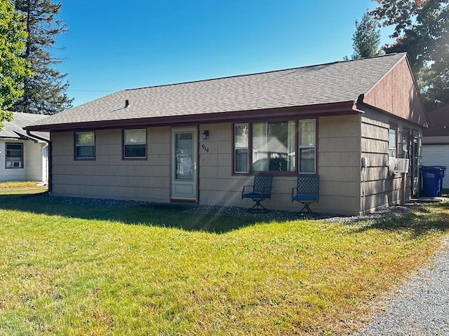 ranch-style home with a front yard and cooling unit