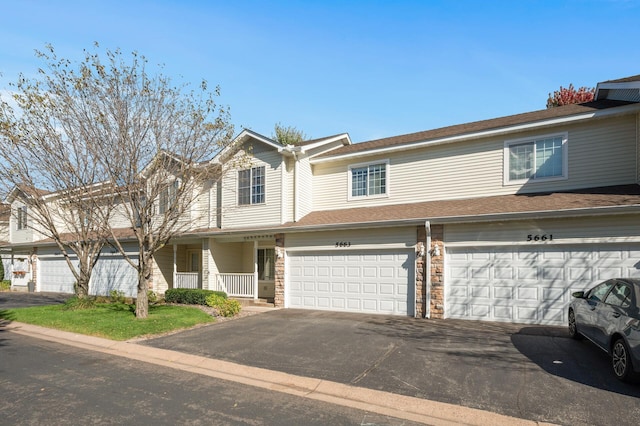 multi unit property with a garage and covered porch