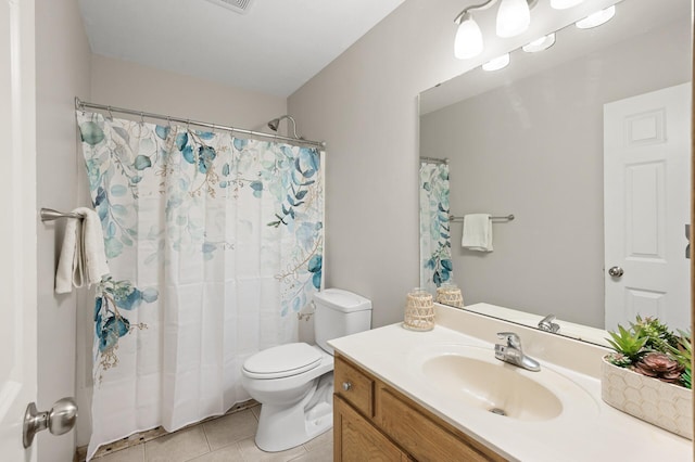 bathroom with tile patterned flooring, a shower with curtain, vanity, and toilet