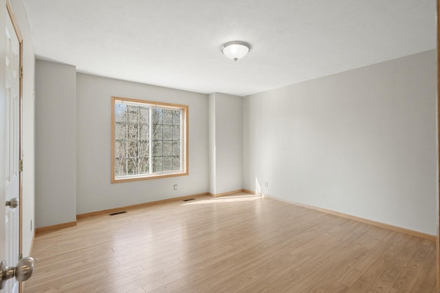 spare room with light wood-type flooring