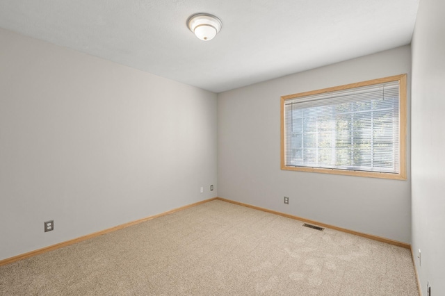 empty room featuring light carpet