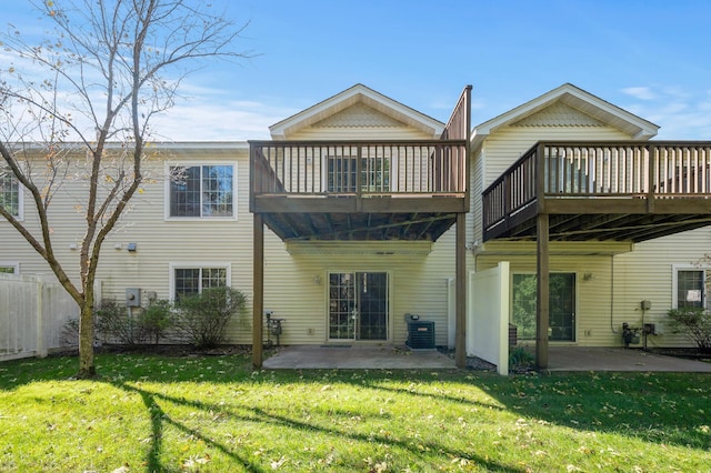 back of property with a yard and a patio