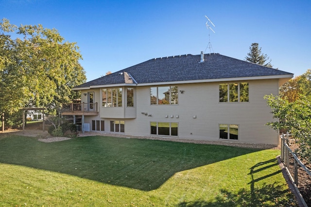 rear view of house featuring a yard