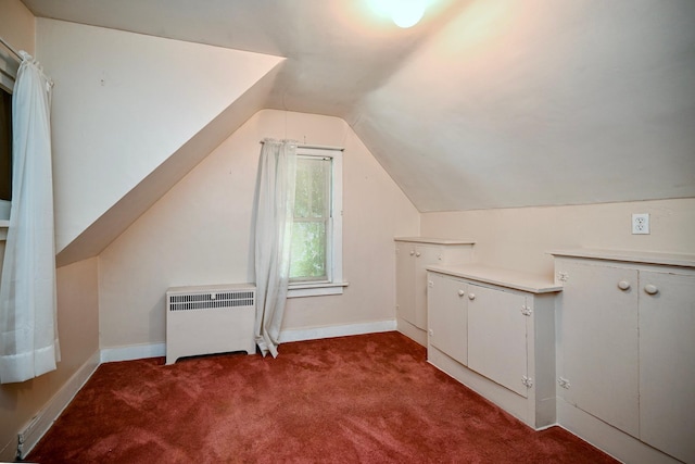 additional living space with lofted ceiling, carpet floors, and radiator heating unit