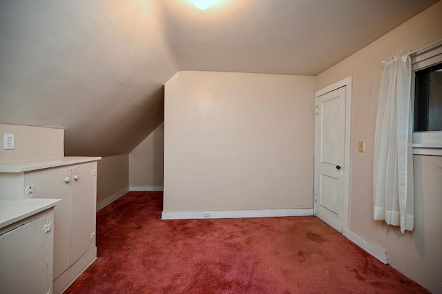 bonus room with carpet floors and vaulted ceiling