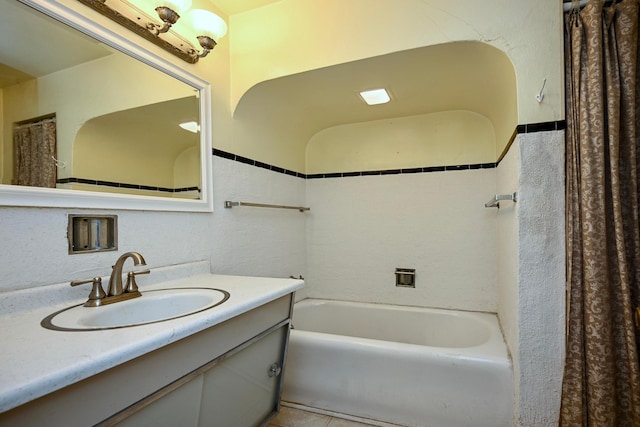 bathroom with vanity, shower / bathtub combination with curtain, and tile patterned floors