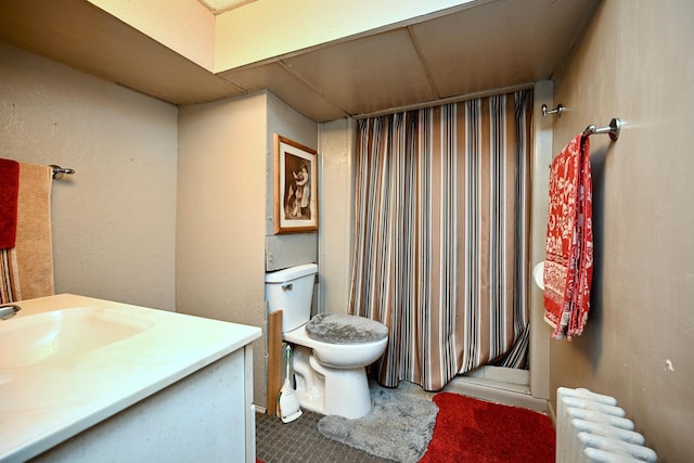 bathroom with radiator, vanity, a shower with curtain, and toilet