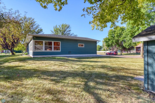 rear view of property featuring a lawn