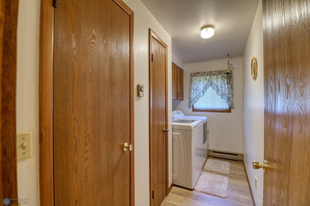 washroom with separate washer and dryer, cabinets, baseboard heating, and light hardwood / wood-style floors