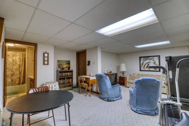 interior space with a paneled ceiling and carpet flooring