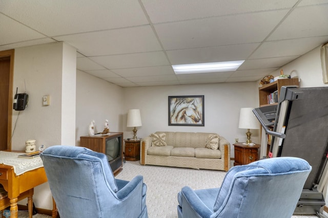 carpeted living room with a drop ceiling