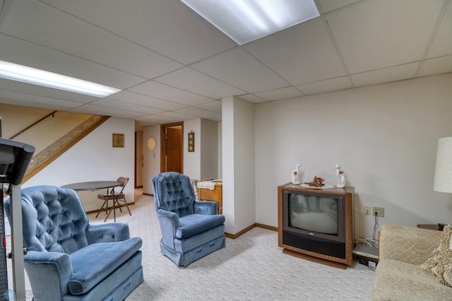 carpeted living room featuring a paneled ceiling