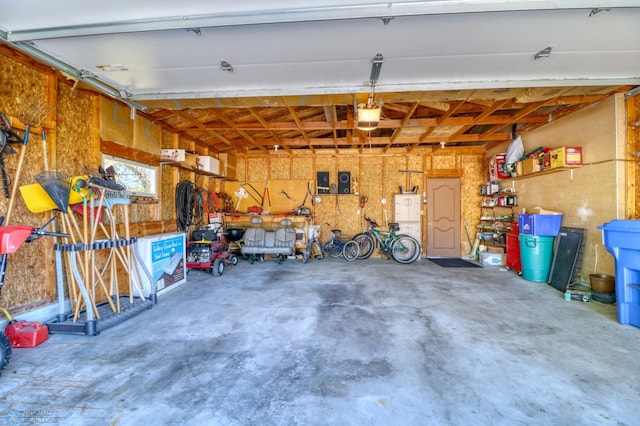 garage featuring a garage door opener and a workshop area