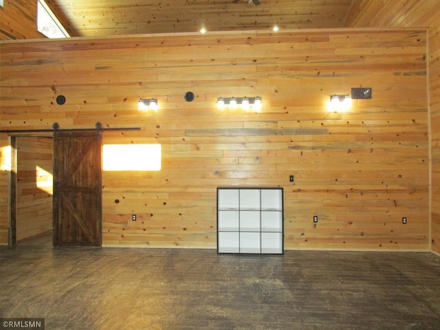 spare room with a barn door and wooden ceiling