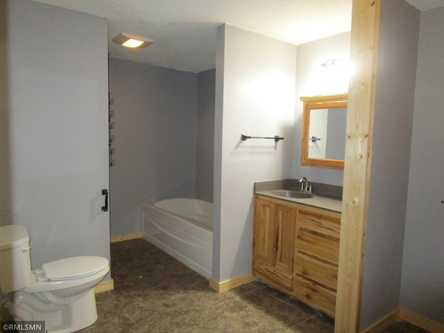 bathroom featuring a bathtub, vanity, toilet, and baseboards