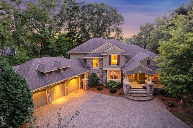 view of front facade featuring a porch and a garage