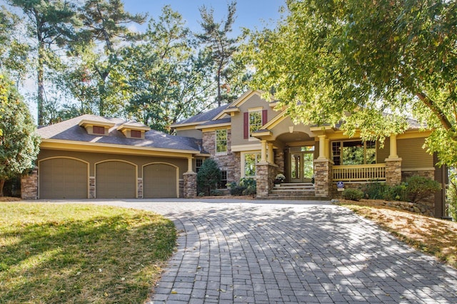 view of front of property featuring a garage and a front lawn