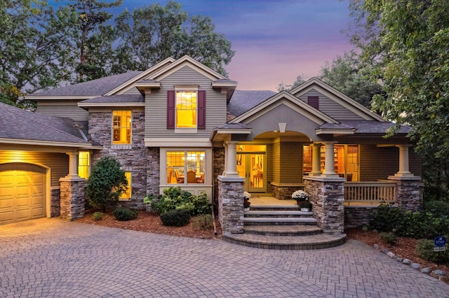 view of front facade featuring a porch and a garage