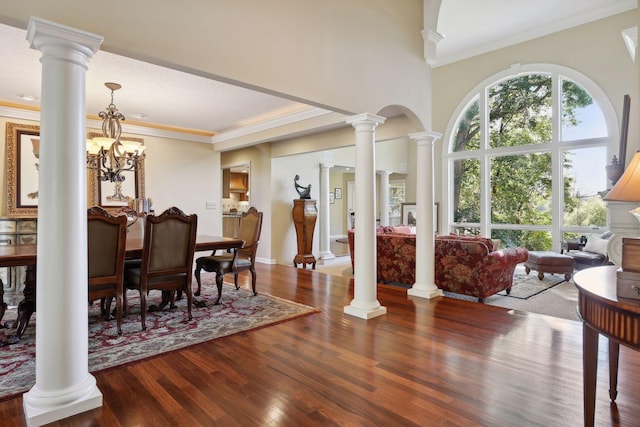 dining room featuring crown molding, wood-type flooring, and a chandelier