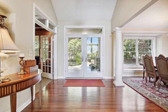 entryway featuring lofted ceiling, french doors, decorative columns, and dark hardwood / wood-style flooring