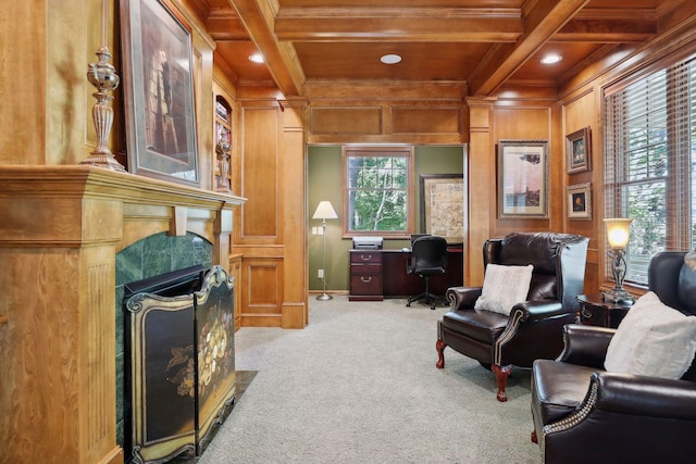 sitting room featuring light carpet, wood walls, beam ceiling, and a fireplace