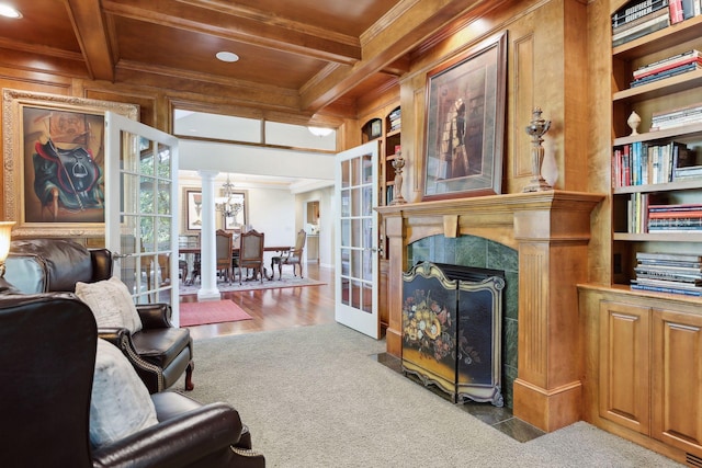 living room featuring coffered ceiling, beamed ceiling, light hardwood / wood-style flooring, and ornamental molding