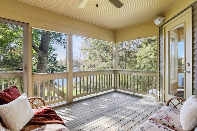 sunroom featuring ceiling fan