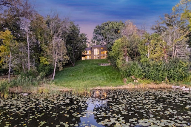 yard at dusk with a water view