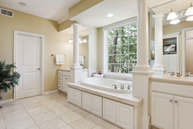 bathroom featuring vanity, tile patterned flooring, an inviting chandelier, and a bathing tub