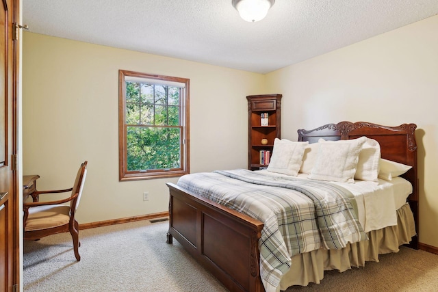 bedroom featuring light carpet and a textured ceiling