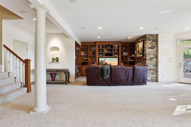 carpeted living room with ornate columns