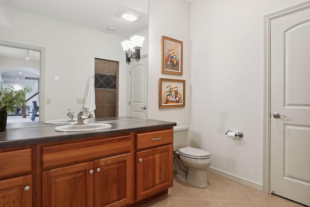 bathroom featuring vanity, toilet, and tile patterned flooring