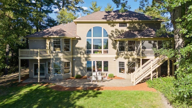 rear view of house with a patio area and a lawn