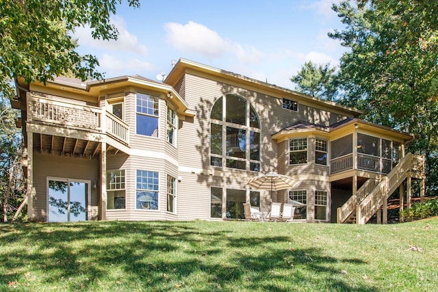 back of house featuring a yard and a sunroom