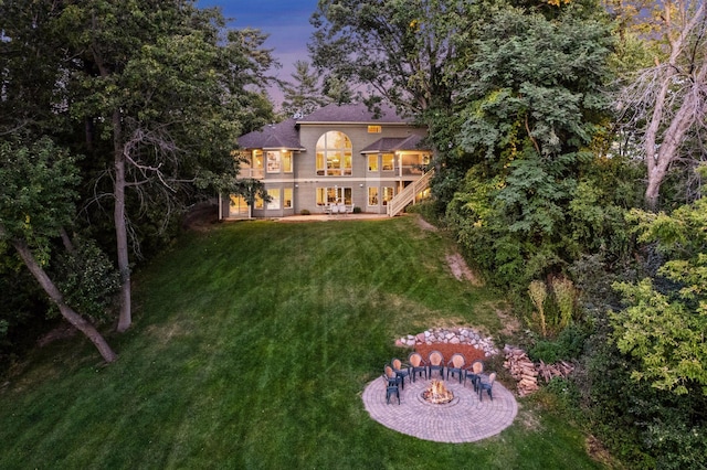 back house at dusk with a yard