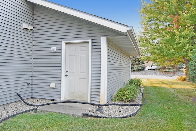 entrance to property featuring a lawn