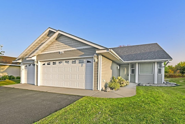 single story home featuring aphalt driveway, a front lawn, a shingled roof, and a garage