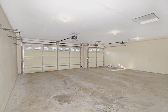 garage featuring a garage door opener and baseboards