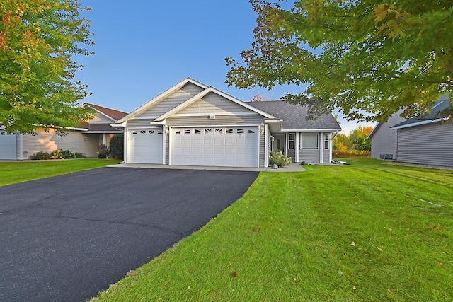 view of front of property with a garage and a front lawn