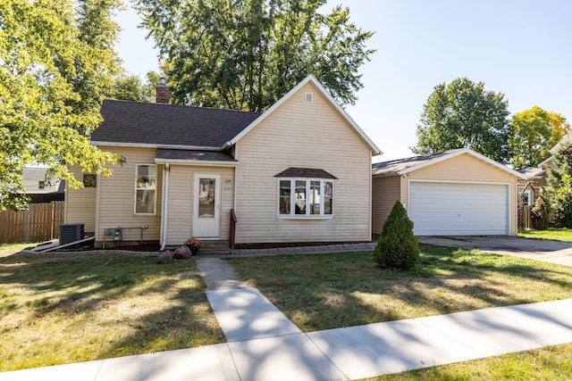 view of front of house with fence, a garage, a front yard, central AC unit, and a chimney