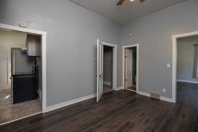 unfurnished bedroom with visible vents, baseboards, and dark wood-style floors