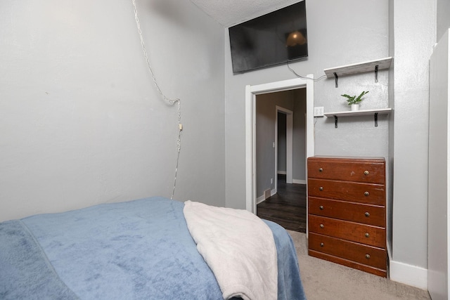 carpeted bedroom featuring baseboards