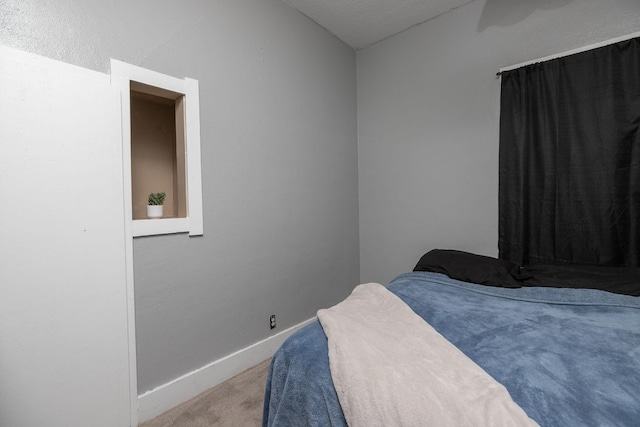 carpeted bedroom featuring baseboards