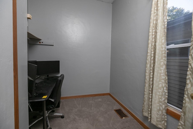 carpeted home office with baseboards and visible vents