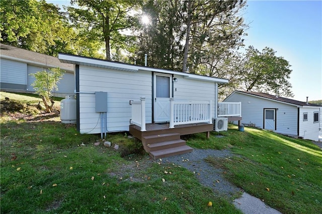 back of house with a yard and a deck